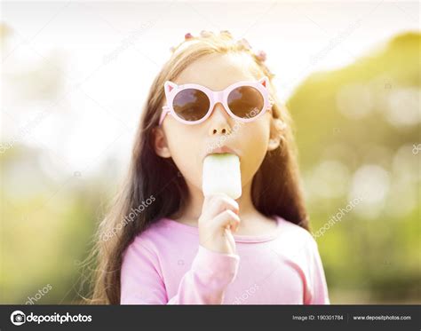 Happy Little Girl Eating Popsicle Summertime Stock Photo By ©tomwang