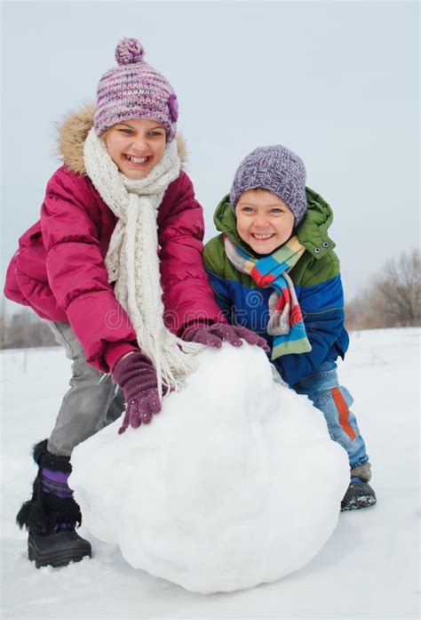 Your bum will be a little cold in this ensemble, but it will totally be worth it! Kids make a snowman stock image. Image of friends ...