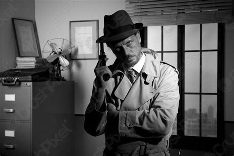 Film Noir Detective Holding A Revolver And Posing Stock Photo 620923