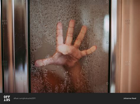Hand Of Girl Pressed Up Against Glass Door Of The Shower Stock Photo OFFSET
