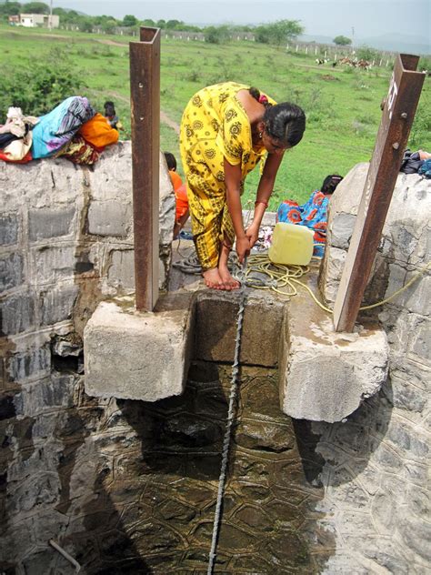 Stock Pictures Women Filling Water From Village Well In India