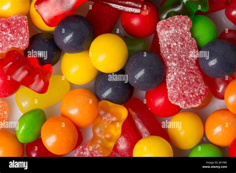 Closeup Of Various Types Of Candy Scattered On White Stock Photo Alamy