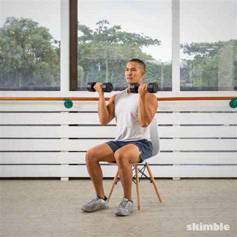 Seated Dumbbell Front Raises Exercise How To Workout Trainer By Skimble