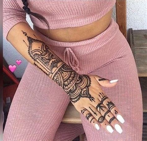 A Woman With Henna Tattoos On Her Arm