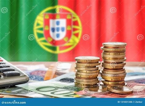 Euro Banknotes And Coins In Front Of The National Flag Of Portugal