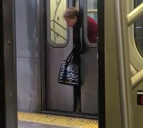 WATCH NYC Subway Riders Ignore Woman With Head Stuck In Doors