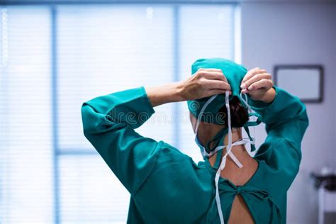 Rear View Of Female Surgeon Wearing Surgical Mask In Operation Theater