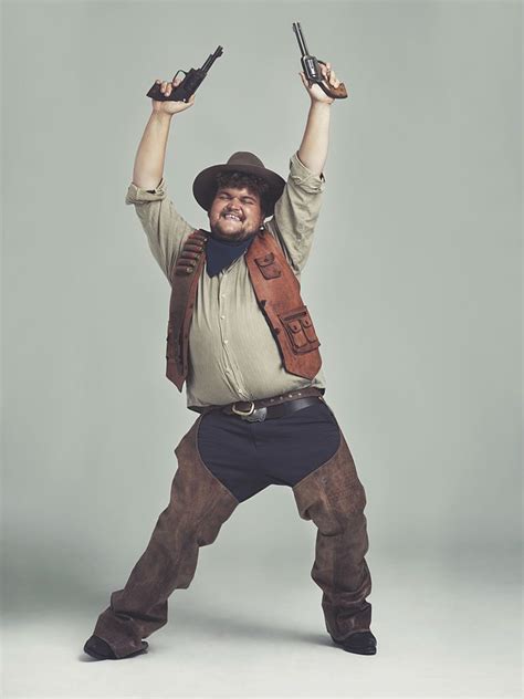 An Overweight Cowboy Looking Ecstatic With His Pistols In The Air
