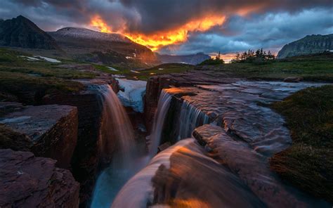 glow nature sunrise triple falls montana glacier national park waterfall storm clouds