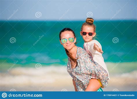 Beautiful Mother And Daughter At Caribbean Beach Enjoying Summer