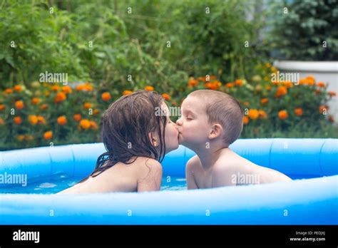 Children Bathe In An Inflatable Blue Swimming Pool Stock Photo Alamy