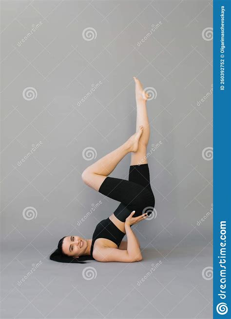 Athletic Young Woman Doing Fitness Or Yoga Lying On The Floor And