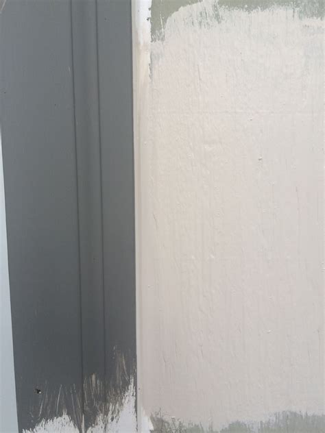 The Corner Of A Room With White Paint On It
