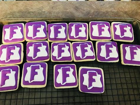 Purple And White Decorated Cookies Sitting On Top Of A Cooling Rack