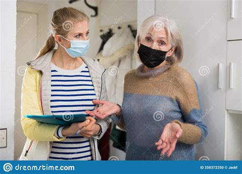 Mature Woman In Protective Mask Answers Questions Of Interviewer At