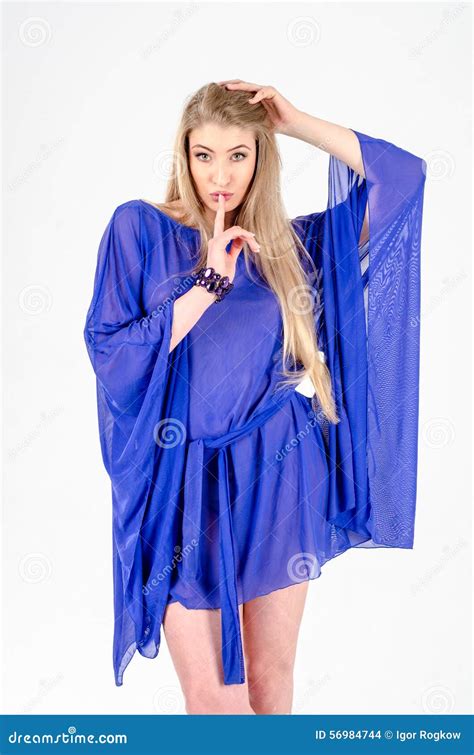 Beautiful Long Haired Blonde In A Clear Blue Tunic And Blue Shoes Stock