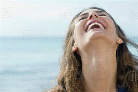 Young Woman Laughing Outdoors With Head Back And Eyes Closed Stock