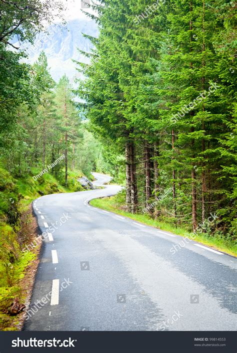 Scenic Winding Road Through Green Forest In Norway Stock Photo 99814553