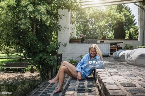 Mature Woman Sitting On Terrace Steps Photo Getty Images