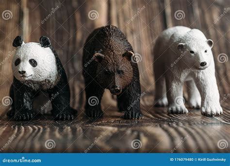 Figure Of A Toy Polar Bear Brown Bear And Panda On A Wooden Background