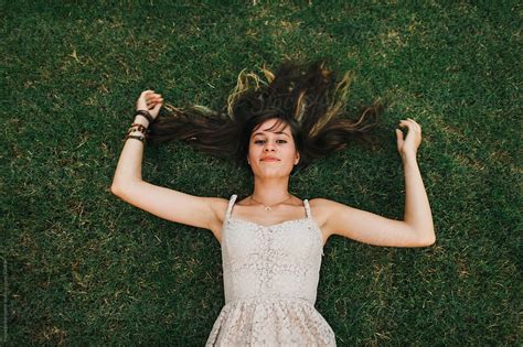 Teenage Girl Laying In Grass By Stocksy Contributor Michelle Edmonds Stocksy