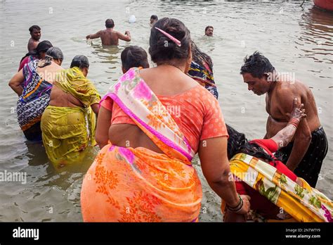 Women And Men Praying And Bathing In The Ghats Of Ganges River Varanasi Uttar Pradesh India