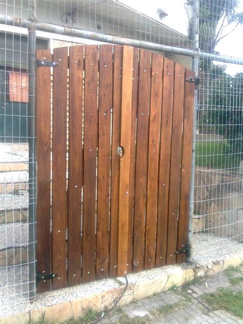 The Gate Is Made Of Wood And Has Rivets On It S Sides