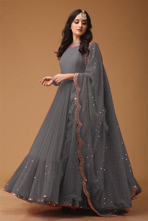 Here's the light color gown that looks so amazing on every girls. Pretty Grey Colored Georgette Fabric Party Wear Mirror Work Anarkali Suit With Dupatta - AS1003
