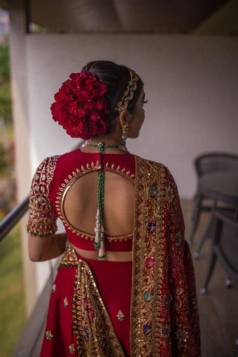 Photo Of Stunning Bridal Bun With Red Roses Bridal Hair Decorations Bridal Hairstyle Indian