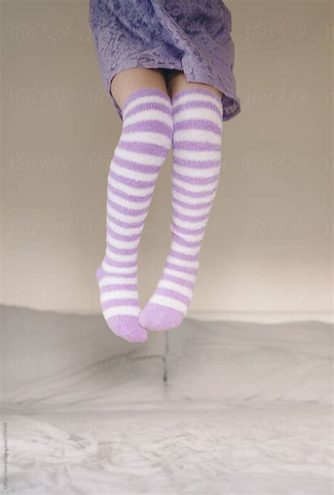 Girl Jumping On The Bed In Purple Stripey Socks Del Colaborador De