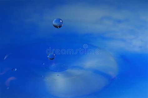 Macro Shot Of Water Drop Falling In Blue Water Stock Photo Image Of