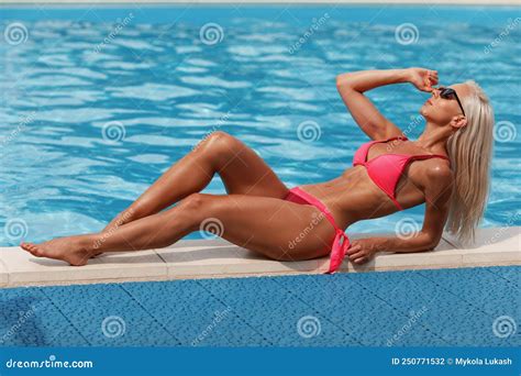 Woman In Bikini Enjoying Summer Sun And Tanning During Holidays In Pool Beautiful Girl In