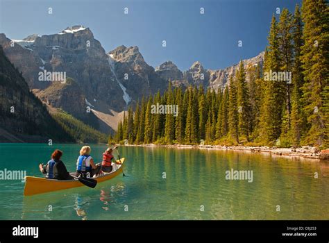 Three Women Canoeing On Moraine Lake Banff National Park Alberta