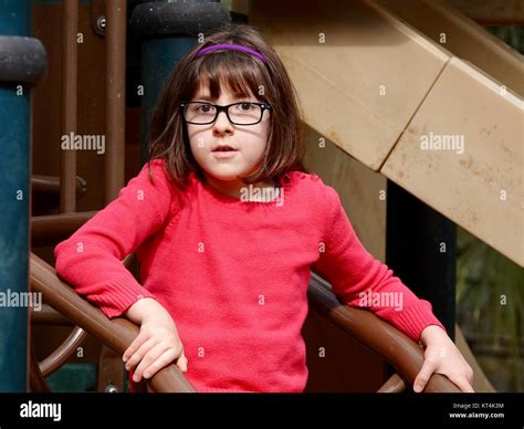 Close Up Of Young Girl With Glasses On Playground Stock Photo Alamy
