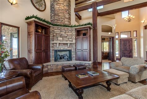 Living Room With Two Story Fireplace And Massive Beams Living Room