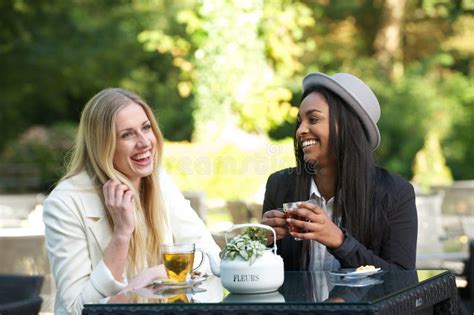 Multicultural Friends Laughing And Drinking Tea Stock Image Image Of