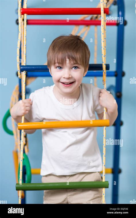 Kid Boy Climbing A Rope Ladder Stock Photo Alamy