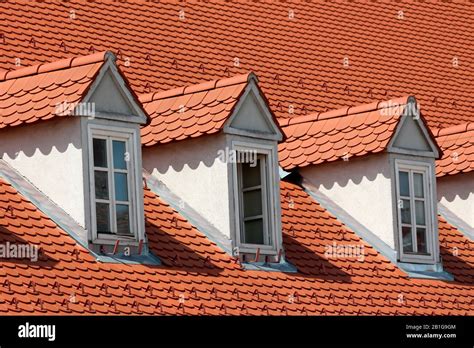 Row Of Renovated Old Style Roof Windows Covered With New Red Roof Tiles