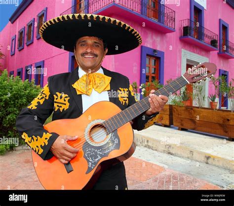Charro Mariachi Singer Playing Guitar In Mexico Houses Background Stock