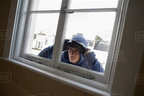 Burglar Looking Through Window Stock Photo Dissolve
