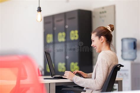 Beautiful Girl Working On A Laptop In A Modern Coworking Space