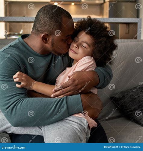 Father Embracing And Kissing Son On Sofa At Home Stock Photo Image Of