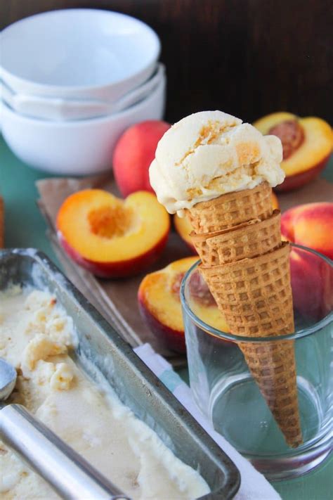 An Ice Cream Sundae With Peaches On The Side And A Scoop Of Ice Cream