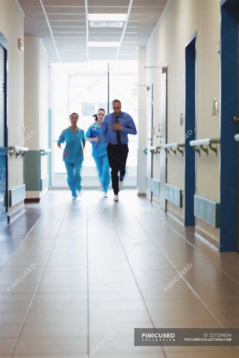 Doctor And Nurses Running In Passageway Of Hospital During Emergency — Occupation Surgeons