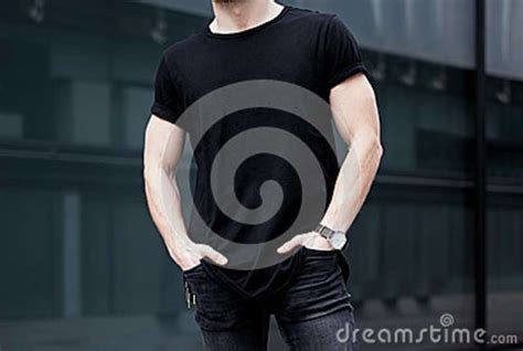 Young Caucasian Muscular Man Wearing Black Tshirt And Jeans Posing In