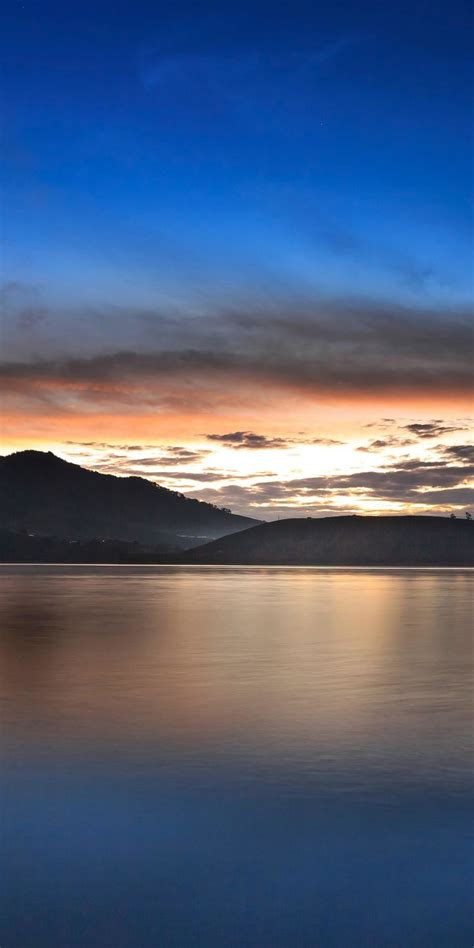 1080x2160 Mountains Silhouette Lake Sunset Wallpaper Scenery