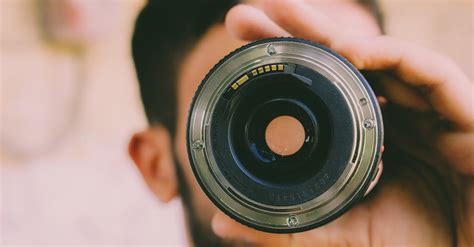 Selective Focus Photography Of Man Holding Camera Lens · Free Stock Photo