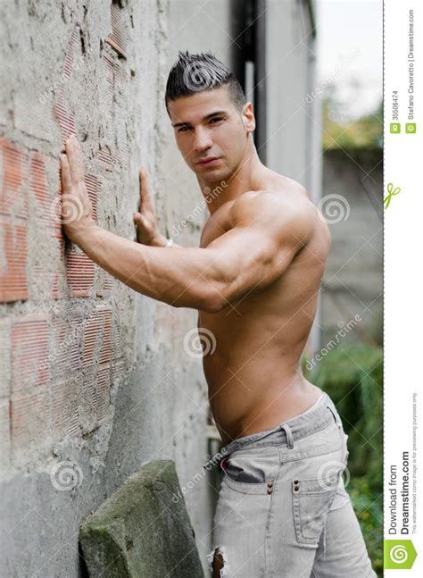 Muscular Young Latino Man Shirtless In Jeans Leaning
