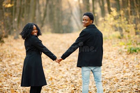 Loving Black Couple Walking In Park And Enjoying Autumn Day Stock Image