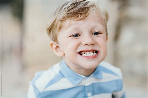 Cute Little Boy Grinning And Showing His Teeth By Stocksy Contributor